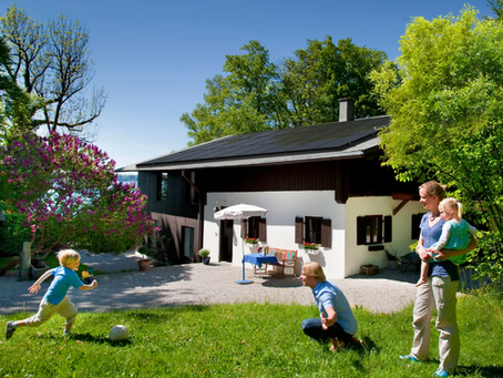 Family playing in the yard of a home with rooftop solar