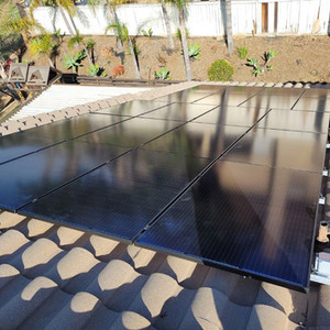 Solar panels on a patio roof beside a landscaped wall