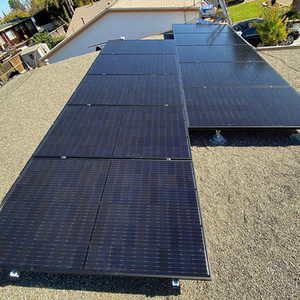 Large rooftop solar array installed on a gravel roof